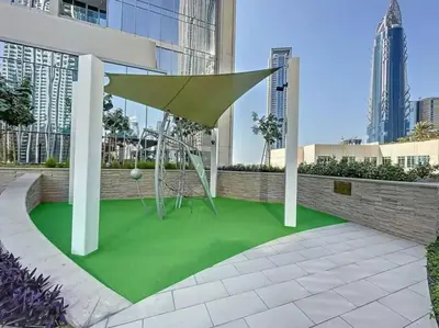 a playground with a swing on a green floor in a building at 3BR Burj Khalifa Fountain Views Forte 1- 18th floor in Dubai
