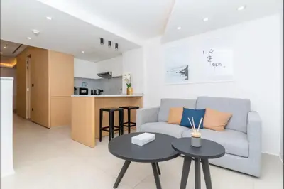 a living room with a couch and two tables at AWS Holiday Homes - Oasis in the Palm in Dubai