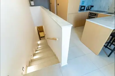 a staircase leading up to a kitchen with a table at AWS Holiday Homes - Oasis in the Palm in Dubai