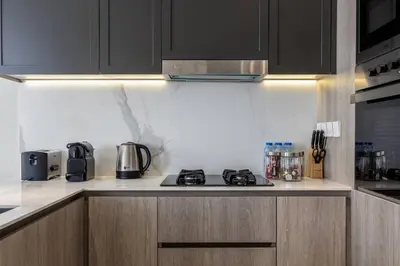 a kitchen with a stove and appliances in it at Waves - Tranquil Living 2BR Apt in JVC with City Views in Dubai