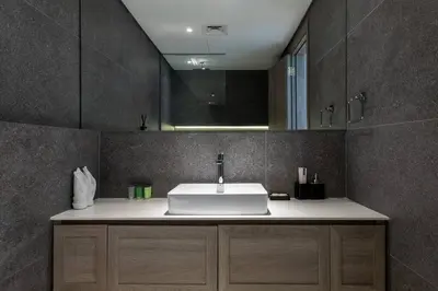 a bathroom with a sink and a mirror at Waves - Tranquil Living 2BR Apt in JVC with City Views in Dubai