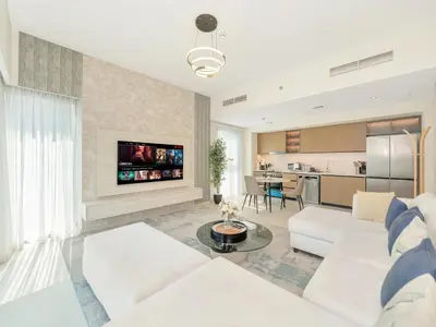 a living room with white furniture and a kitchen at 2BR Burj Khalifa & Fountain Views Burj Crown 39th Floor in Dubai