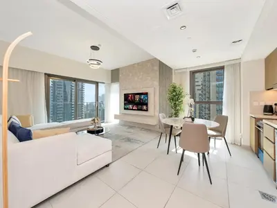 a living room with a white couch and a table at 2BR Burj Khalifa & Fountain Views Burj Crown 39th Floor in Dubai