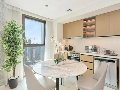a kitchen with a table and chairs in a kitchen at 2BR Burj Khalifa & Fountain Views Burj Crown 39th Floor in Dubai