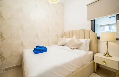 a bedroom with a bed with a blue bag on it at NewArabian Dubai HillsMaple Villa in Dubai