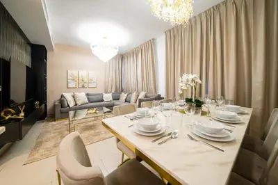 a living room with a dining room table with chairs at NewArabian Dubai HillsMaple Villa in Dubai