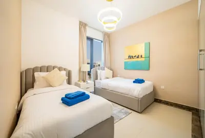 a bedroom with two beds and a window at NewArabian Dubai HillsMaple Villa in Dubai