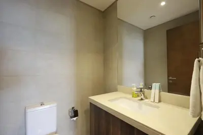 a bathroom with a sink and a mirror at Livbnb-Tranquil 1B Steps to PalmBoardwalk Sea View in Dubai