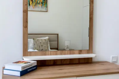 a mirror on top of a table with books at Aesthetic 2BR with Marina Waterfront View in Dubai