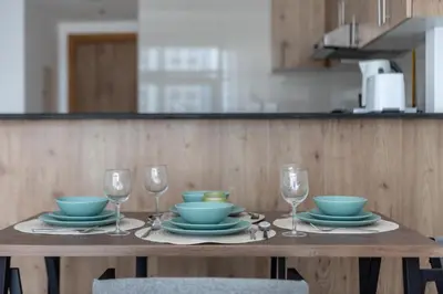 a table with bowls and plates and glasses on it at Aesthetic 2BR with Marina Waterfront View in Dubai