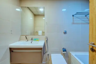 a bathroom with a sink and a mirror and a toilet at Aesthetic 2BR with Marina Waterfront View in Dubai