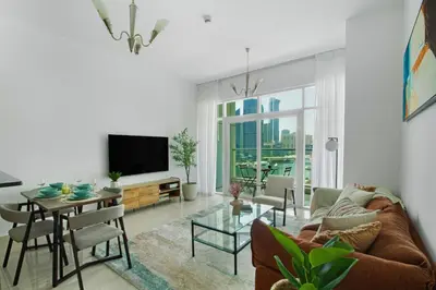 a living room with a couch and a table at Aesthetic 2BR with Marina Waterfront View in Dubai