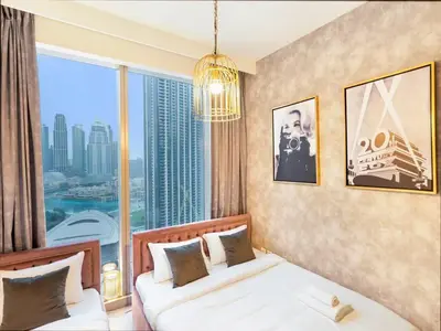 a bedroom with a bed and a large window at Panoramic Full Fountain,Opera& burj Sky View 4BR APT in Dubai