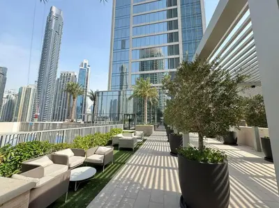 a balcony with couches and trees on a building at Panoramic Full Fountain,Opera& burj Sky View 4BR APT in Dubai