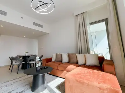 a living room with a couch and a table at Stunning 2 Bedroom Apartment Downtown Views 2 - Tower 3 Downtown Dubai in Dubai