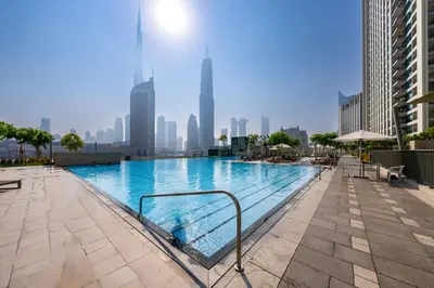 a swimming pool with a city skyline in the background at Exclusive front row seats to Burj Khalifa fireworks from penthouse level, downtown Dubai in Dubai
