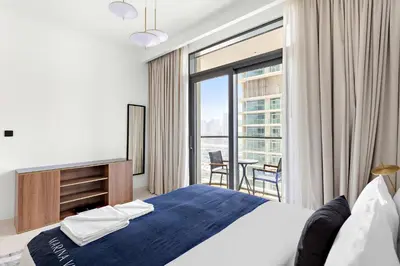 a bedroom with a bed and a large window at Silkhaus Palm View in Marina Vista Private Beach in Dubai