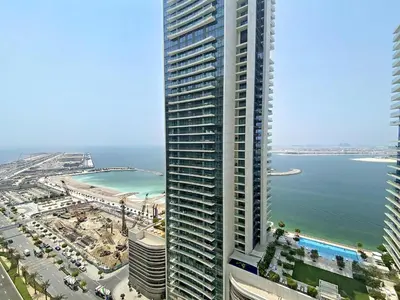 an aerial view of a tall building next to the ocean at Silkhaus Palm View in Marina Vista Private Beach in Dubai
