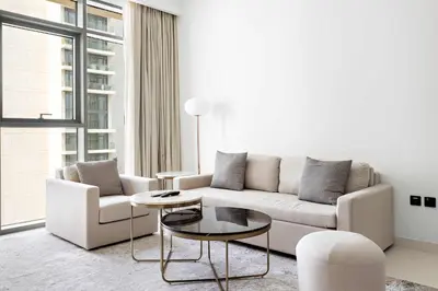 a living room with a couch and a table at Silkhaus Palm View in Marina Vista Private Beach in Dubai