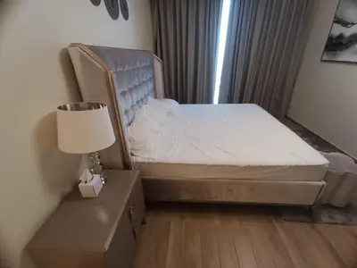 a bedroom with a bed with a lamp and a window at Al Quoz 2 Bed Budget Apartment in Dubai