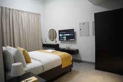 a bedroom with a bed and a television in it at Ista Vacation Homes Rental LLC KARAMA in Dubai