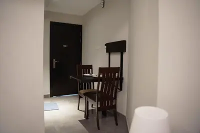 a room with a table and two chairs and a door at Ista Vacation Homes Rental LLC KARAMA in Dubai