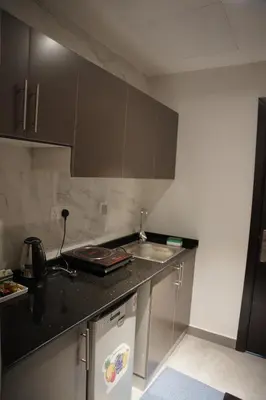 a kitchen with a sink and a counter top at Ista Vacation Homes Rental LLC KARAMA in Dubai