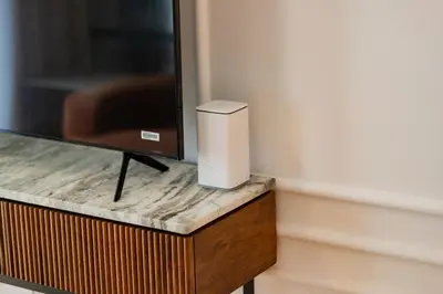 a television with a speaker on a wooden table at Elite Escapes - Socio Stylish 1 BHK Getaway in Dubai