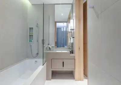 a white bathroom with a shower and a sink at Premium Stay at The Address Residences JBR in Dubai