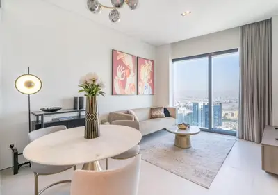 a living room with a table and a couch at Premium Stay at The Address Residences JBR in Dubai