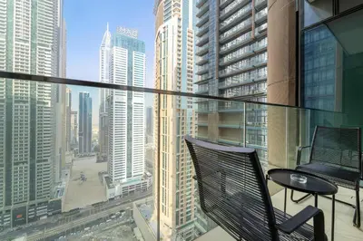 a balcony with a table and chairs on a building at Silkhaus Modern Dubai Marina 1BDR Marina Gate in Dubai