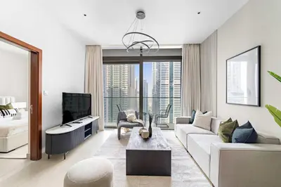 a living room with a couch and a tv at Silkhaus Modern Dubai Marina 1BDR Marina Gate in Dubai