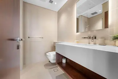 a bathroom with a sink and a toilet and a mirror at Silkhaus Modern Dubai Marina 1BDR Marina Gate in Dubai