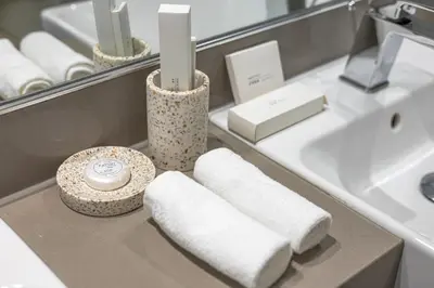a bathroom with towels and a sink and a mirror at 2BR plus M with Huge Balcony City Walk Building 22 in Dubai