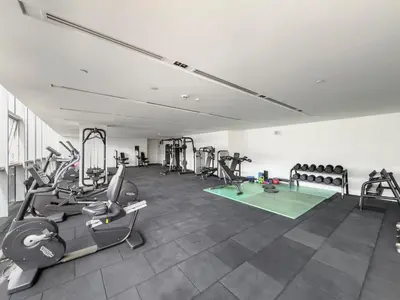 a gym with several treadmills and machines in a room at 2BR plus M with Huge Balcony City Walk Building 22 in Dubai