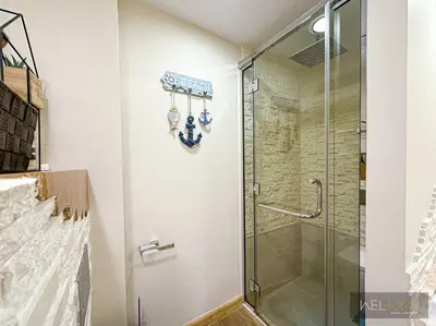 a shower with a glass door in a bathroom at WelHome - Stylish Breathtaking 2BR Apartment in Marina in Dubai