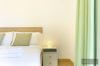 a bedroom with a bed and a nightstand with a vase at WelHome - Stylish Breathtaking 2BR Apartment in Marina in Dubai