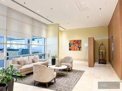 a living room with a couch and a table and chairs at WelHome - Stylish Breathtaking 2BR Apartment in Marina in Dubai
