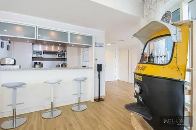 a kitchen with a bar with stools in a room at WelHome - Stylish Breathtaking 2BR Apartment in Marina in Dubai