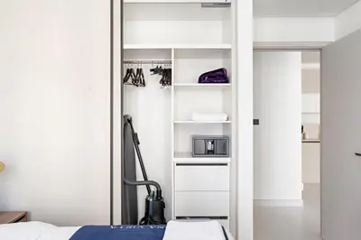 a bedroom with a bed and a white closet at Silkhaus 1BDR with Private Beach Skyline Views in Dubai