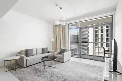 a living room with a couch and a table at Silkhaus 1BDR with Private Beach Skyline Views in Dubai
