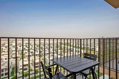 a table and chairs on a balcony with a view of a city at Blueground Dubai Hills Estate balcony elev DXB-1120 in Dubai