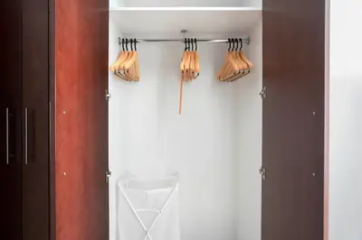 a closet with utensils hanging on a wall at Blueground Burj Views A sauna game room DXB-1386 in Dubai