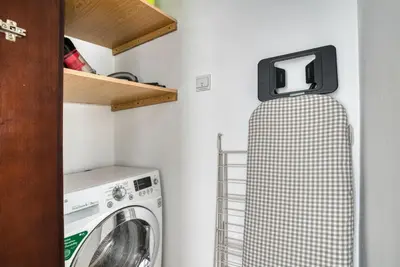 a laundry room with a washer and dryer at Blueground Burj Views A sauna game room DXB-1386 in Dubai