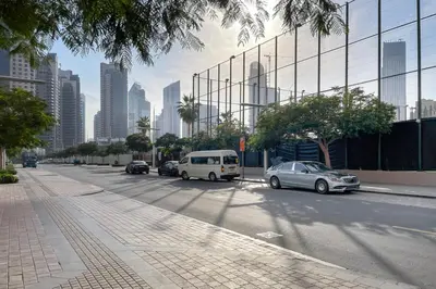 a street with cars parked on the side of the road at Blueground Burj Views A sauna game room DXB-1386 in Dubai