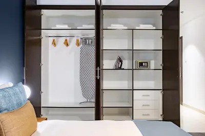 a bedroom with a bed and a glass closet at Blueground Sheikh Zayed Rd pool gym DXB-545 in Dubai