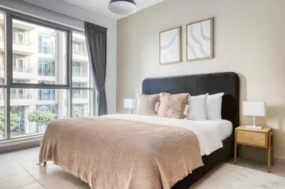 a bedroom with a large bed with a large window at Blueground Boulevard Central pool gym DXB-1179 in Dubai