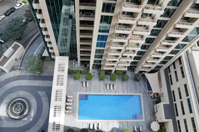 an overhead view of an apartment complex with a swimming pool at Blueground Boulevard Central pool gym DXB-1179 in Dubai