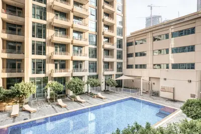 an overhead view of a swimming pool in front of a building at Blueground Boulevard Central pool gym DXB-1179 in Dubai