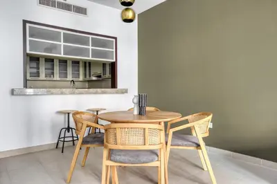 a dining room with a wooden table and chairs at Blueground Boulevard Central pool gym DXB-1179 in Dubai